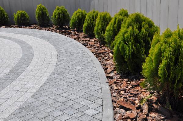Landscaping Ideas for Driveway Entrances driveway entrance landscaping with shrubs, stone border, and lighting