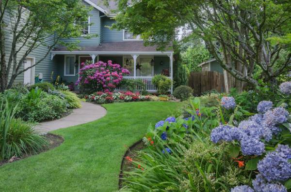 Modern Front Yard Landscaping Ideas Modern front yard landscaping with stone border, shrubs, and clean pathway