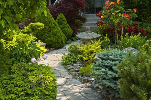 Pathway and Walkway Landscaping Ideas stone garden pathway lined with shrubs and outdoor lighting