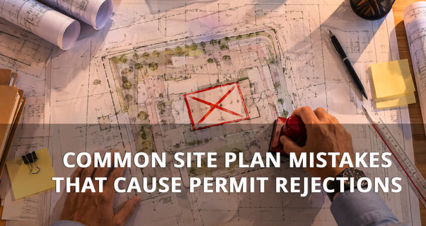 site plan drawing on drafting table marked with permit rejection notice